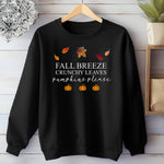 Black Gildan sweatshirt featuring a festive fall-themed design with colorful autumn leaves, the phrase “Fall Breeze, Crunchy Leaves, Pumpkins Please” in mixed fonts, and four orange pumpkin icons along the bottom. A cozy and stylish piece perfect for embracing crisp air, seasonal vibes, and pumpkin spice everything.