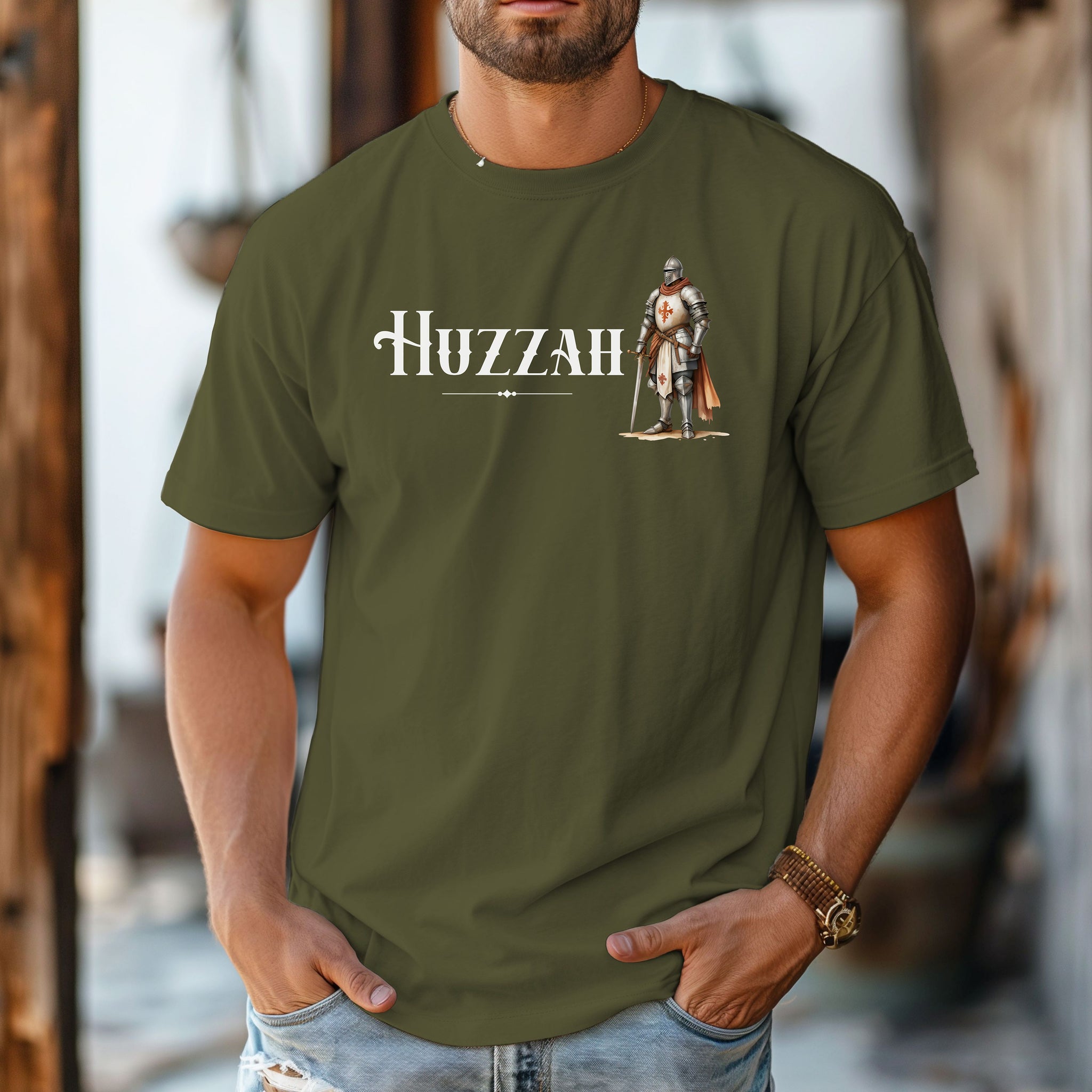 Hemp T-shirt featuring a Renaissance Faire design with the word “Huzzah” in medieval-style lettering and an illustration of a knight in shining armor. Perfect for Renaissance fair goers, medieval enthusiasts, and fans of historical festivals, celebrating the lively and spirited call of “Huzzah” at fairs and events.