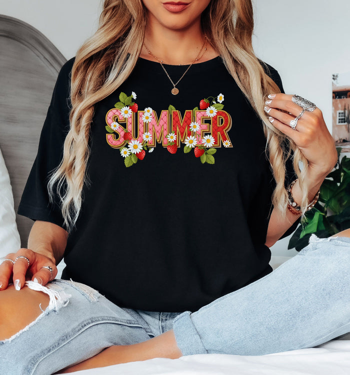 Black T-shirt featuring a vibrant “SUMMER” graphic decorated with red strawberries, green leaves, and white daisies. The fresh, playful design captures a bright and cheerful summer vibe, perfect for casual warm-weather outfits.