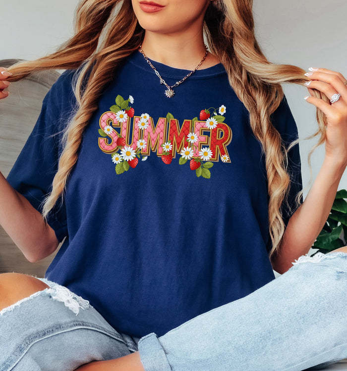 True Navy T-shirt featuring a vibrant “SUMMER” graphic decorated with red strawberries, green leaves, and white daisies. The fresh, playful design captures a bright and cheerful summer vibe, perfect for casual warm-weather outfits.