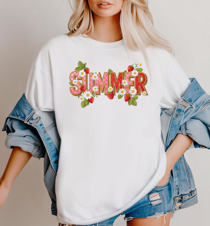 White T-shirt featuring a vibrant “SUMMER” graphic decorated with red strawberries, green leaves, and white daisies. The fresh, playful design captures a bright and cheerful summer vibe, perfect for casual warm-weather outfits.