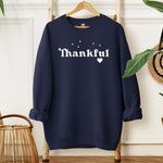 Navy Gildan sweatshirt featuring the word “Thankful” in bold white retro-style font, accented with small sparkling stars above and a heart below. A simple yet meaningful design that celebrates gratitude and cozy fall vibes—perfect for Thanksgiving, autumn gatherings, or everyday wear.