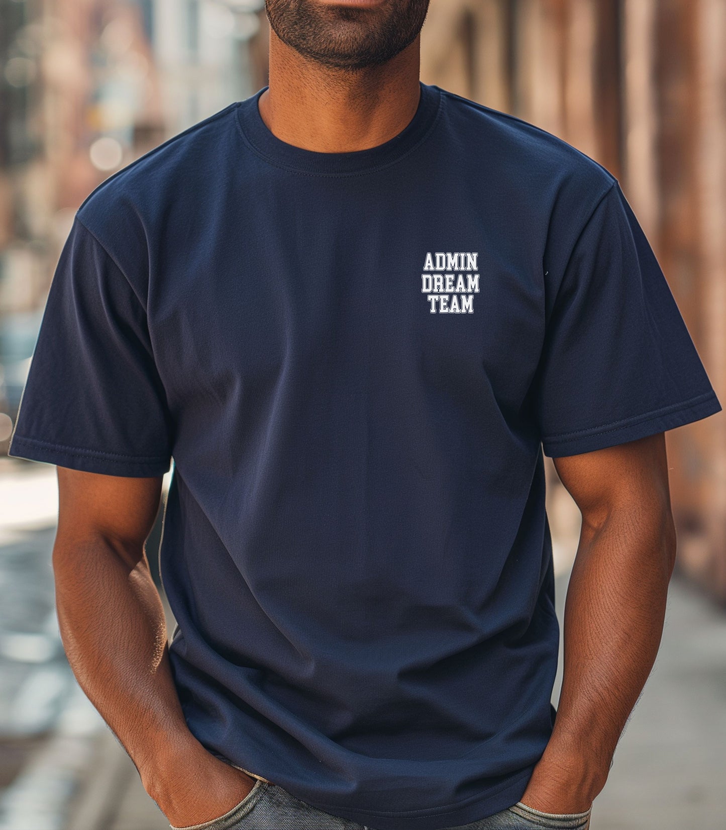 Person wearing a Navy t-shirt, featuring a minimalist white text design on the left chest that reads "ADMIN DREAM TEAM." Perfect for school staff, office teams, or administrative professionals showing team spirit in a stylish and understated way.