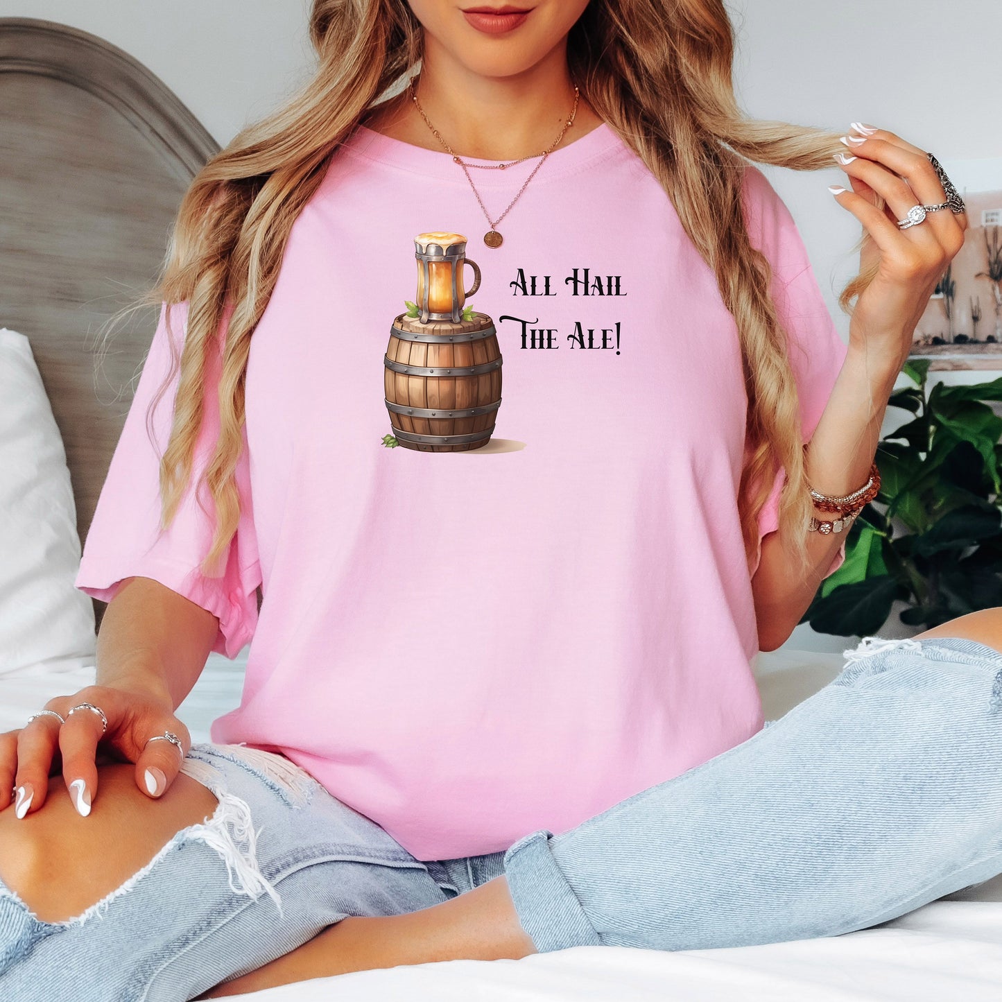 Blossom pink T-shirt with a Renaissance Faire-inspired design featuring a wooden ale barrel topped with a frothy mug of beer and the phrase “All Hail The Ale!” in medieval-style lettering. A fun and festive shirt perfect for fair lovers, pub crawls, and anyone who enjoys the lively spirit of ale and medieval celebrations.