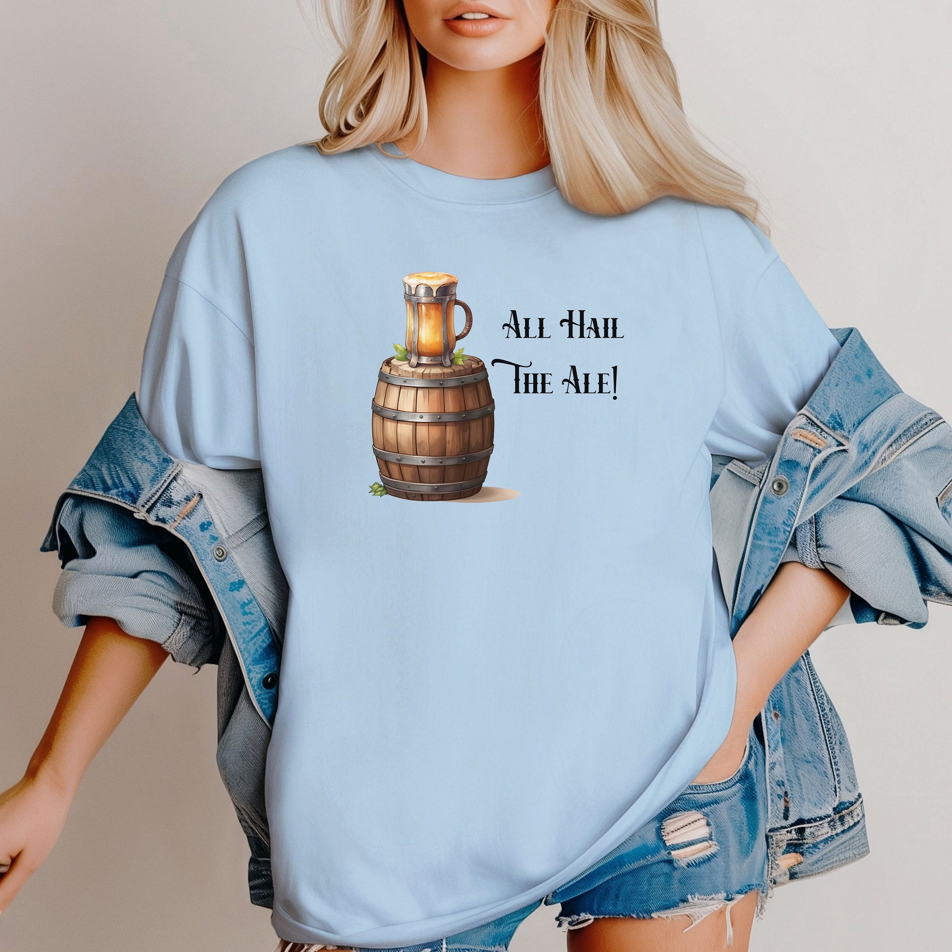 Chambray Light blue T-shirt with a Renaissance Faire-inspired design featuring a wooden ale barrel topped with a frothy mug of beer and the phrase “All Hail The Ale!” in medieval-style lettering. A fun and festive shirt perfect for fair lovers, pub crawls, and anyone who enjoys the lively spirit of ale and medieval celebrations.