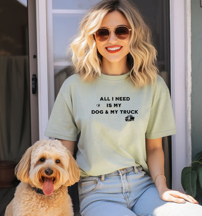All I Need is My Dog & My Truck T-shirt featuring bold black text with small graphic icons of a paw print heart and a pickup truck. Printed on a bay unisex tee, this casual design is perfect for dog lovers and truck enthusiasts who embrace a laid-back, country lifestyle. Ideal for everyday wear, gifting, or showing off two favorite passions—dogs and trucks.