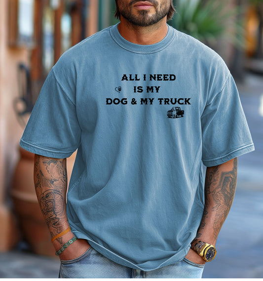 All I Need is My Dog & My Truck T-shirt featuring bold black text with small graphic icons of a paw print heart and a pickup truck. Printed on a washed denim unisex tee, this casual design is perfect for dog lovers and truck enthusiasts who embrace a laid-back, country lifestyle. Ideal for everyday wear, gifting, or showing off two favorite passions—dogs and trucks.
