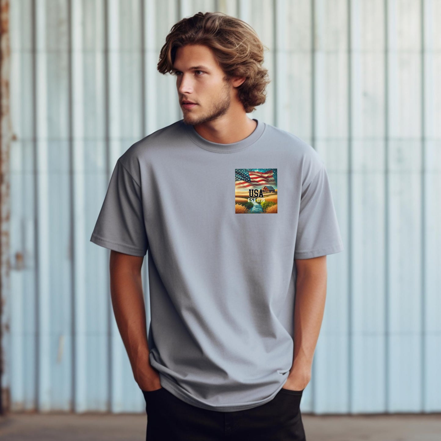 Granite t-shirt featuring a patriotic pocket design with an American flag waving over a scenic farmland landscape at sunset. The design includes the text 'USA EST 1776,' symbolizing pride and heritage. Perfect for 4th of July, country living, and casual patriotic style with a subtle, classic look.