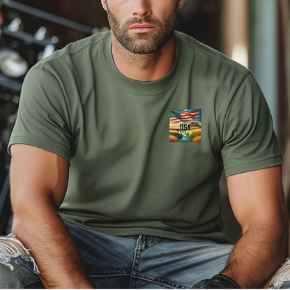 Moss t-shirt featuring a patriotic pocket design with an American flag waving over a scenic farmland landscape at sunset. The design includes the text 'USA EST 1776,' symbolizing pride and heritage. Perfect for 4th of July, country living, and casual patriotic style with a subtle, classic look.
