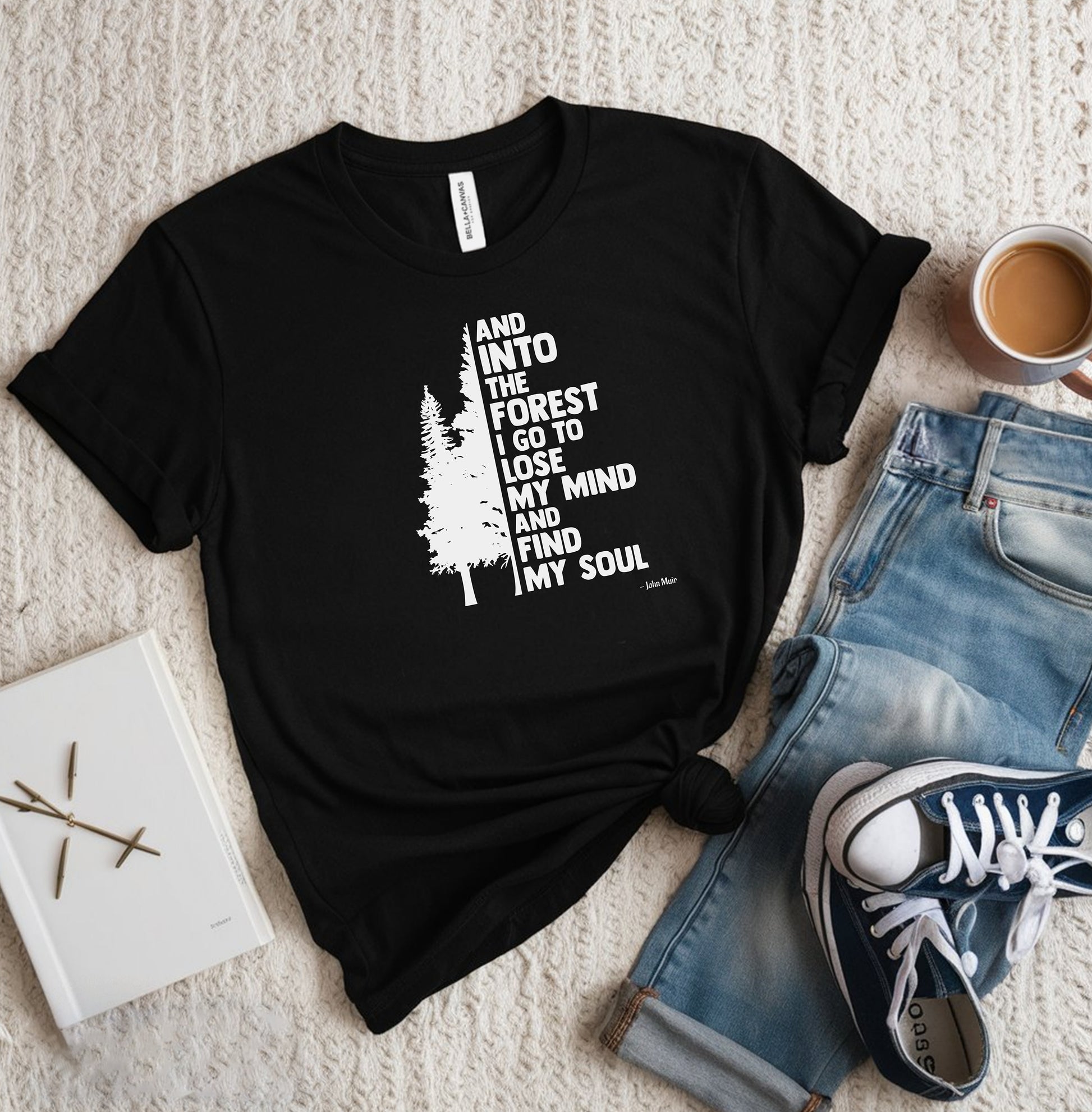 And Into The Forest I Go To Lose My Mind And Find My Soul T-shirt featuring a minimalist nature-inspired design with a tall pine tree alongside bold text of the famous John Muir quote. Printed on a soft black unisex tee, this design celebrates mindfulness, outdoor adventure, and the healing power of nature. Perfect for hikers, campers, and forest lovers who find peace and clarity in the wilderness.