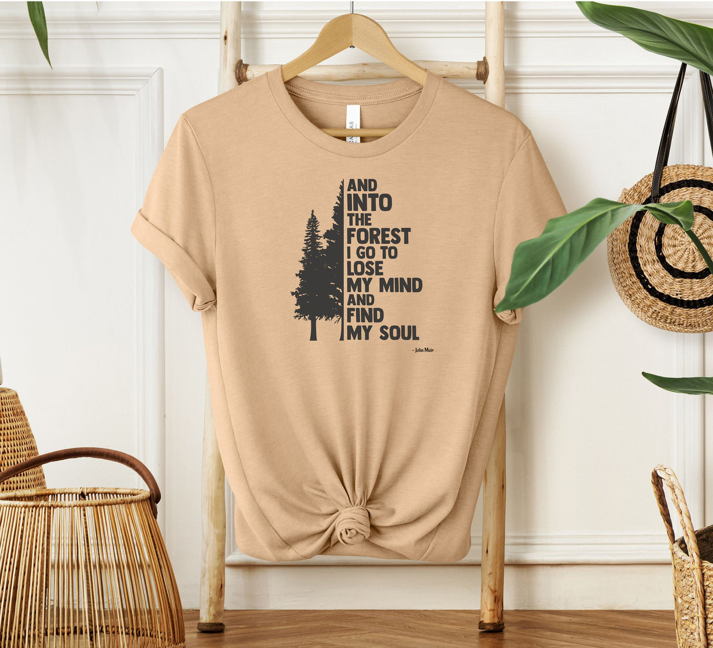 And Into The Forest I Go To Lose My Mind And Find My Soul T-shirt featuring a minimalist nature-inspired design with a tall pine tree alongside bold text of the famous John Muir quote. Printed on a soft heather sand dune unisex tee, this design celebrates mindfulness, outdoor adventure, and the healing power of nature. Perfect for hikers, campers, and forest lovers who find peace and clarity in the wilderness.