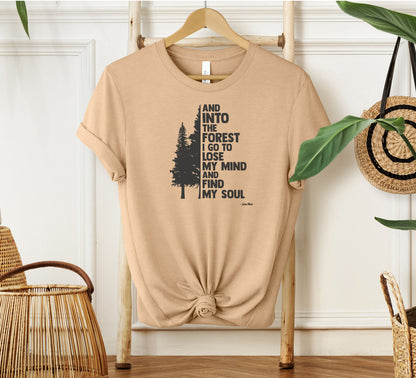 And Into The Forest I Go To Lose My Mind And Find My Soul T-shirt featuring a minimalist nature-inspired design with a tall pine tree alongside bold text of the famous John Muir quote. Printed on a soft heather sand dune unisex tee, this design celebrates mindfulness, outdoor adventure, and the healing power of nature. Perfect for hikers, campers, and forest lovers who find peace and clarity in the wilderness.