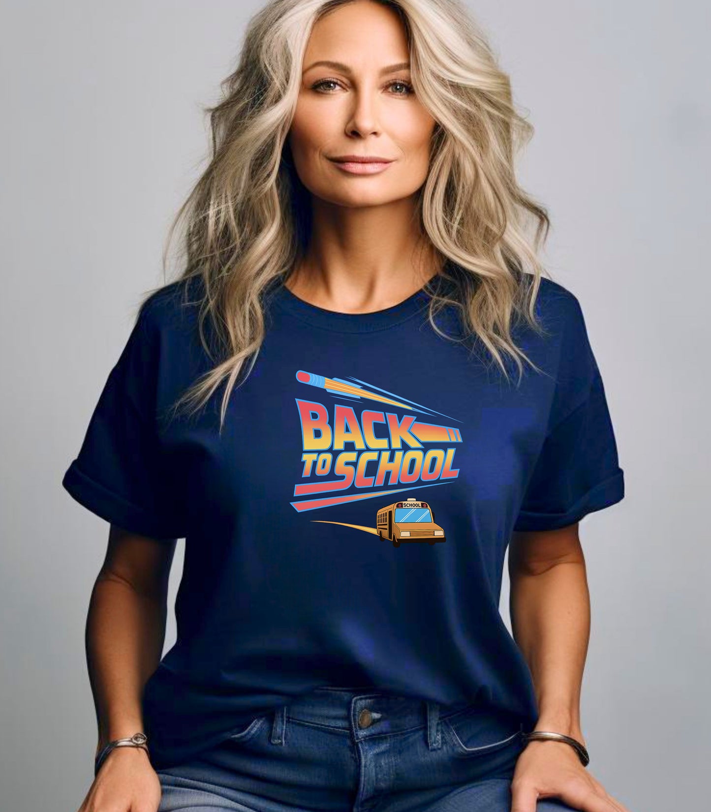 Person wearing a True Navy t-shirt with a bold “Back to School” design featuring retro-style typography, a large pencil graphic above the text, and a yellow school bus driving below. A fun and colorful tee perfect for celebrating the new school year with energy and excitement.