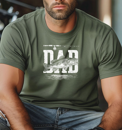 Bass Fishing Dad T-shirt featuring the word 'DAD' in bold, distressed white lettering with a detailed bass fish illustration overlaying the text. A fishing rod graphic runs above the design, with subtle water ripple details below. Printed on a moss unisex tee, this shirt is perfect for dads who love fishing, making it an ideal gift for Father’s Day, birthdays, or weekend fishing trips.