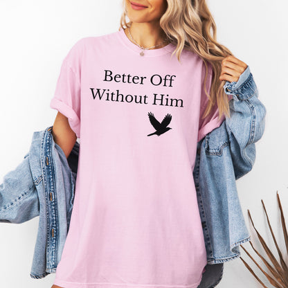 Blossom pink T-shirt with the bold black phrase "Better Off Without Him" printed in a clean serif font, featuring a simple silhouette of a flying black bird that symbolizes freedom and transformation beneath the text. 