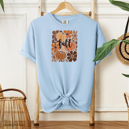 Chambray light blue T-shirt featuring a boho-inspired fall design with hand-drawn pumpkins and flowers in warm autumn tones. The word "fall" is written in elegant script across the center of the graphic, framed by a mosaic-style floral and pumpkin pattern. Perfect for seasonal style and cozy autumn vibes.