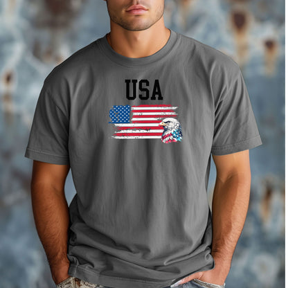 Grey  t-shirt featuring a bold patriotic design with the word 'USA' above a distressed American flag and a fierce bald eagle head on the right side. A strong, classic graphic tee perfect for 4th of July, Memorial Day, Veterans Day, or everyday wear to show American pride and patriotism.