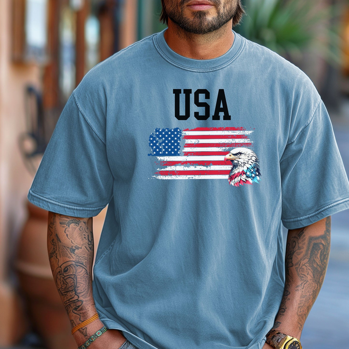 Washed Denim  t-shirt featuring a bold patriotic design with the word 'USA' above a distressed American flag and a fierce bald eagle head on the right side. A strong, classic graphic tee perfect for 4th of July, Memorial Day, Veterans Day, or everyday wear to show American pride and patriotism.