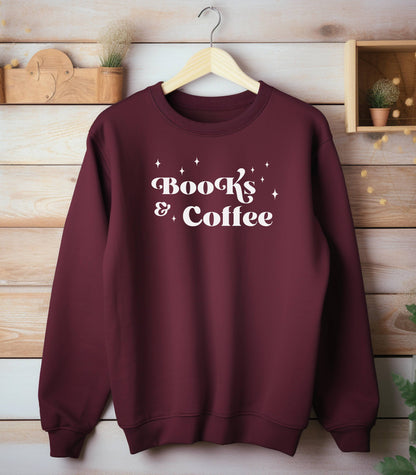 Maroon Gildan sweatshirt featuring a stylish black “Books & Coffee” design in whimsical lettering, accented with small sparkle icons. A cozy and charming look for bookworms and coffee lovers who enjoy slow mornings, warm drinks, and quiet reading time. Perfect for relaxed, literary-inspired outfits.