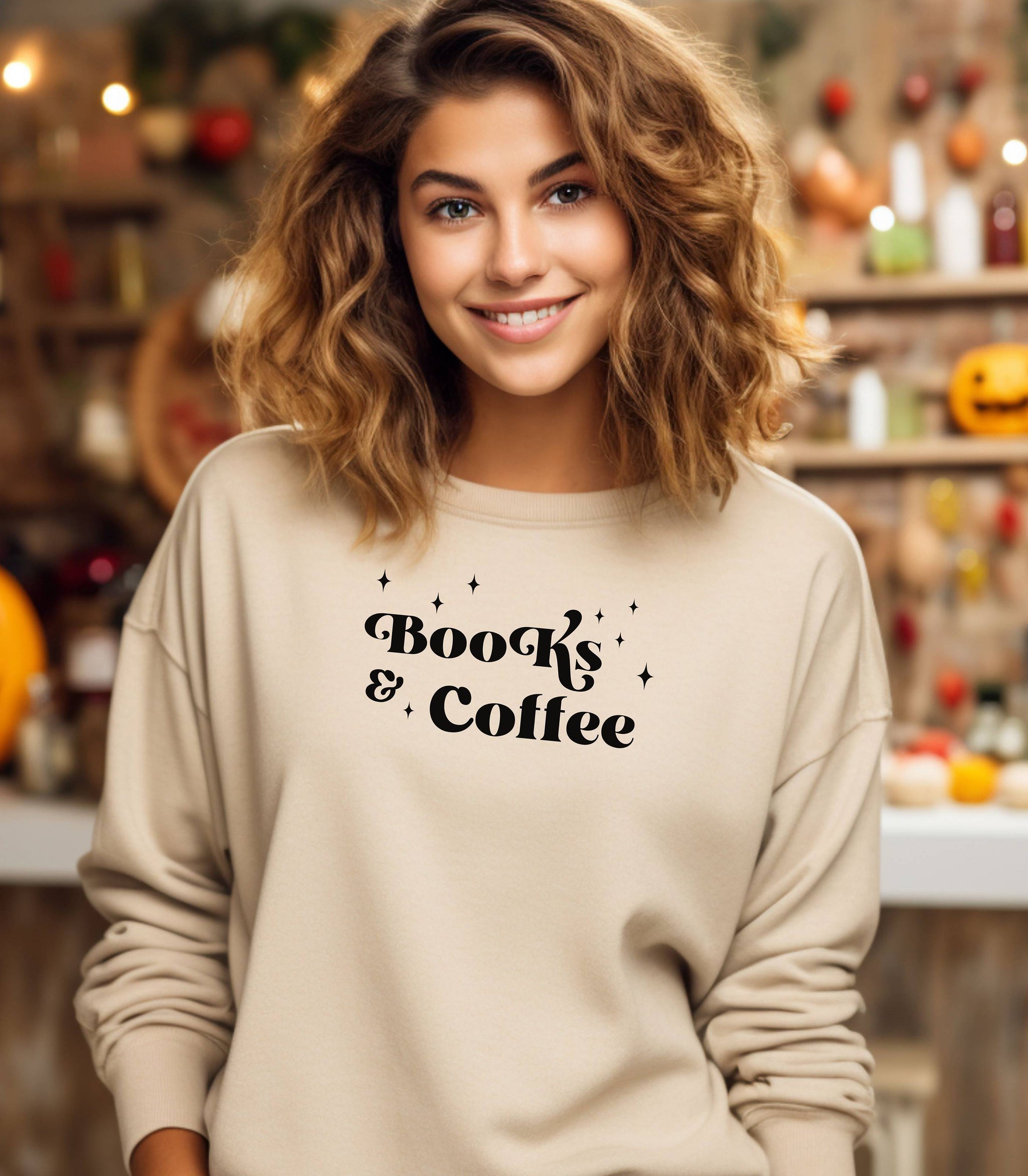 Sand Gildan sweatshirt featuring a stylish black “Books & Coffee” design in whimsical lettering, accented with small sparkle icons. A cozy and charming look for bookworms and coffee lovers who enjoy slow mornings, warm drinks, and quiet reading time. Perfect for relaxed, literary-inspired outfits.