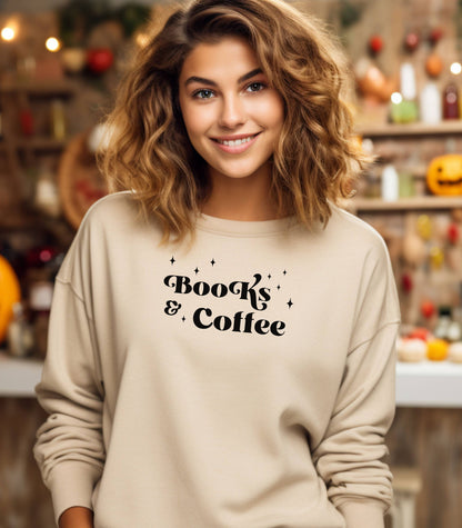 Sand Gildan sweatshirt featuring a stylish black “Books & Coffee” design in whimsical lettering, accented with small sparkle icons. A cozy and charming look for bookworms and coffee lovers who enjoy slow mornings, warm drinks, and quiet reading time. Perfect for relaxed, literary-inspired outfits.