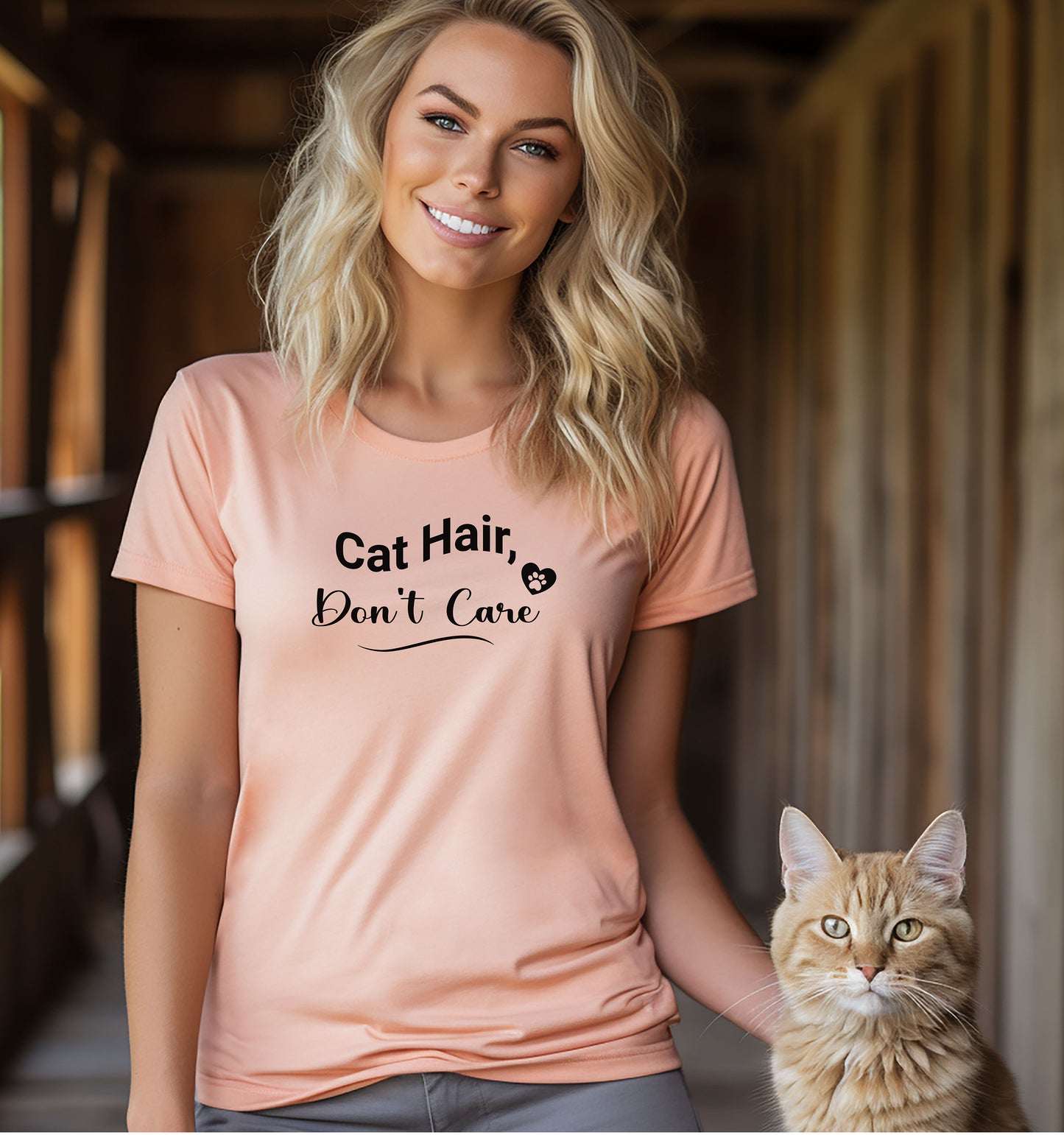 A person wearing a heather peach T-shirt featuring the playful black text “Cat Hair, Don’t Care” with a paw print accent. The design captures a lighthearted message for cat lovers who embrace the joys and messiness of pet ownership, making it a fun, casual fashion choice.