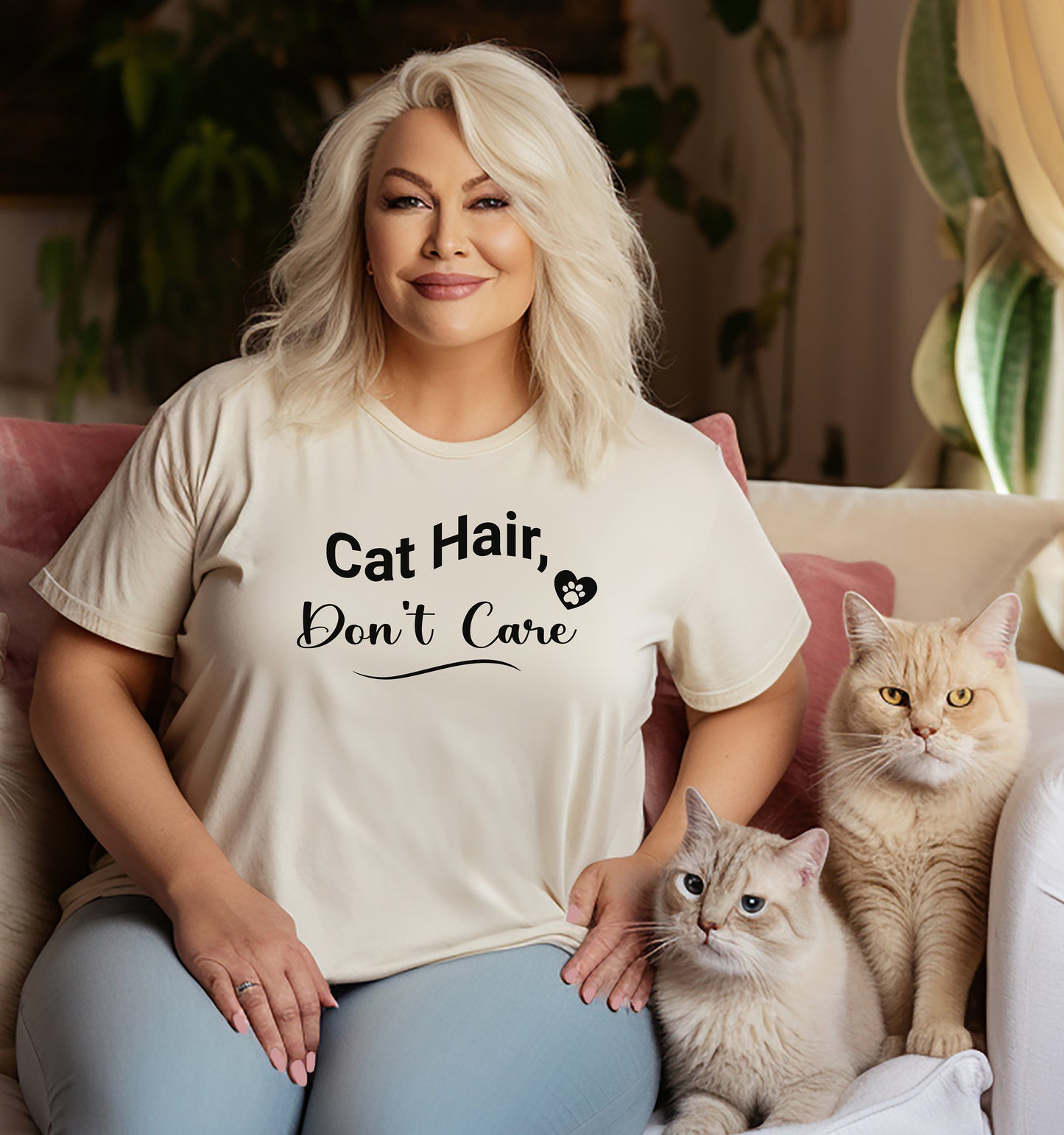 A person wearing a natural T-shirt featuring the playful black text “Cat Hair, Don’t Care” with a paw print accent. The design captures a lighthearted message for cat lovers who embrace the joys and messiness of pet ownership, making it a fun, casual fashion choice.