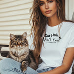 A person wearing a classic white T-shirt featuring the playful black text “Cat Hair, Don’t Care” with a paw print accent. The design captures a lighthearted message for cat lovers who embrace the joys and messiness of pet ownership, making it a fun, casual fashion choice.