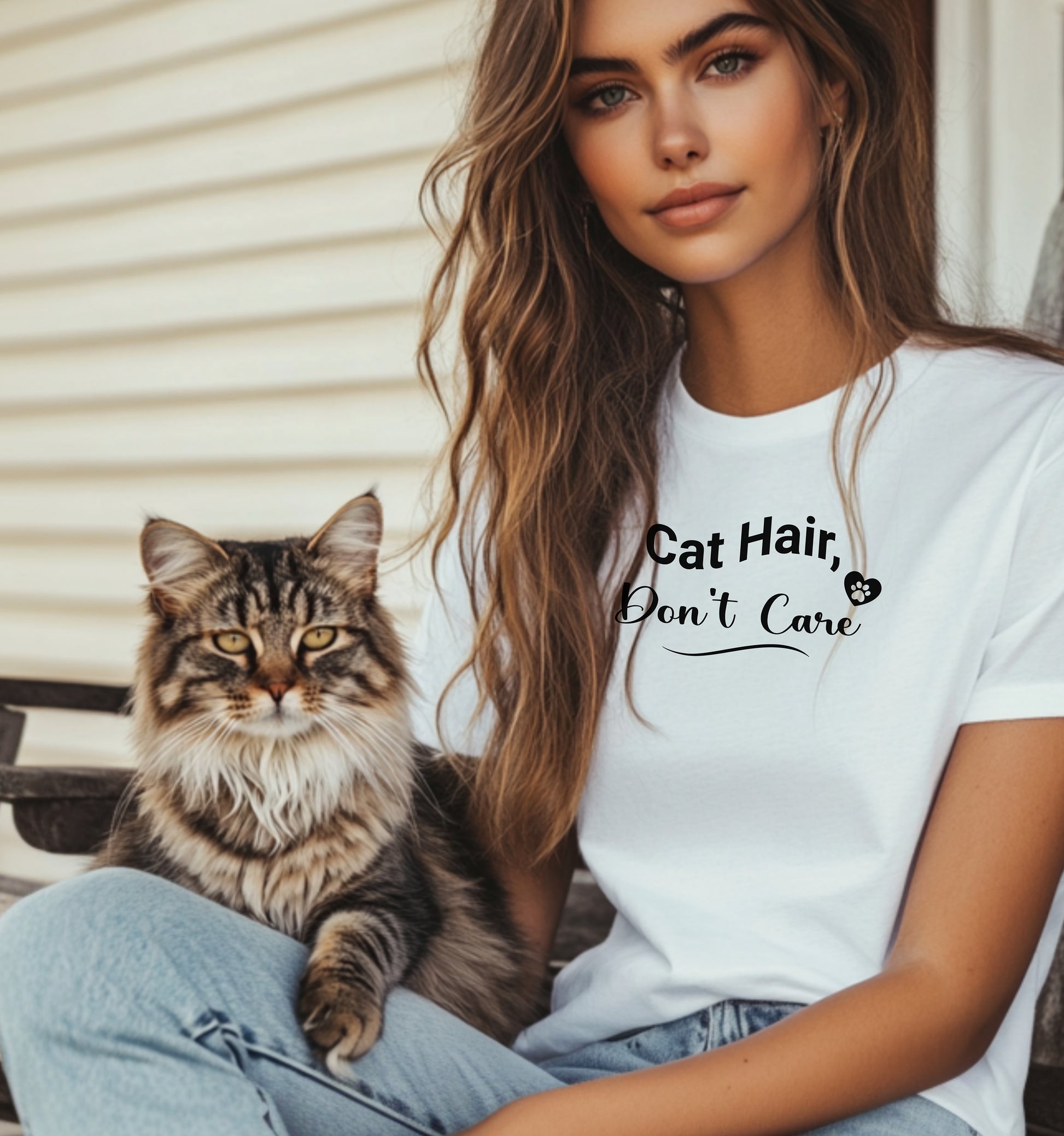 A person wearing a classic white T-shirt featuring the playful black text “Cat Hair, Don’t Care” with a paw print accent. The design captures a lighthearted message for cat lovers who embrace the joys and messiness of pet ownership, making it a fun, casual fashion choice.