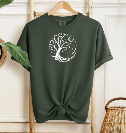 Celestial Tree of Life T-shirt featuring a white mystical tree design within a circular frame of stars, crescent moon, and swirling roots. Printed on a hemp color unisex Comfort Colors tee, this nature-inspired celestial design is perfect for free spirits, stargazers, boho style lovers, and anyone drawn to cosmic, spiritual, or magical themes.