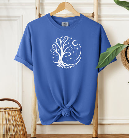 Celestial Tree of Life T-shirt featuring a white mystical tree design within a circular frame of stars, crescent moon, and swirling roots. Printed on a mystic blue unisex Comfort Colors tee, this nature-inspired celestial design is perfect for free spirits, stargazers, boho style lovers, and anyone drawn to cosmic, spiritual, or magical themes.