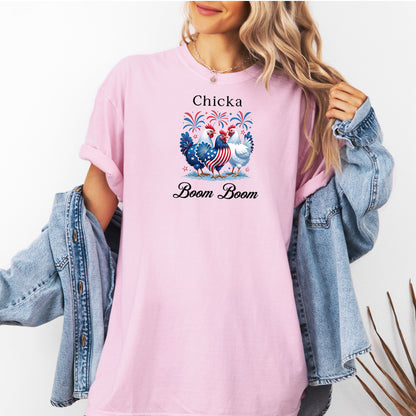Blossom t-shirt featuring a playful 'Chicka Boom Boom' design with three patriotic chickens, one decorated in red, white, and blue stars and stripes, and the other in white, surrounded by colorful fireworks. A third chicken is decorated in red and white stars on a blue body.  A fun and festive shirt perfect for 4th of July, barbecues, summer parties, and casual patriotic celebrations.