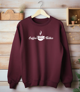 Maroon Gildan sweatshirt with a centered white graphic of a steaming coffee cup and stylish text reading “Coffee before Talkie.” The playful design humorously declares the need for caffeine before conversation—perfect for coffee lovers who enjoy cozy comfort and a touch of sass in their morning routine.