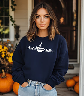 Navy Gildan sweatshirt with a centered white graphic of a steaming coffee cup and stylish text reading “Coffee before Talkie.” The playful design humorously declares the need for caffeine before conversation—perfect for coffee lovers who enjoy cozy comfort and a touch of sass in their morning routine.