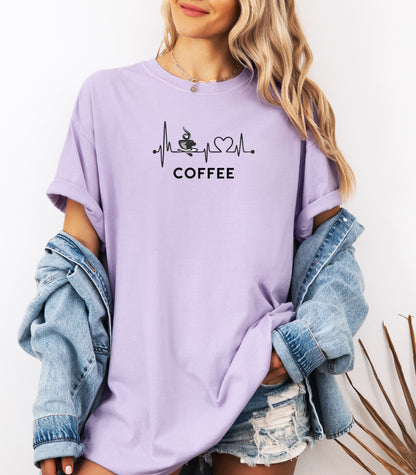 Graphic Orchid t-shirt design featuring a heartbeat line that flows through a steaming coffee cup and forms a heart shape before it finishes. A creative and stylish illustration that shows coffee is essential to life—perfect for caffeine lovers, baristas, and anyone whose heart beats for coffee.