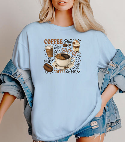 Chambray light blue t-shirt featuring a playful coffee-themed design with multiple illustrated coffee cups, beans, and the word “coffee” repeated in various fonts and styles. Centered around a steaming cup of coffee on a saucer, this fun and cozy graphic is perfect for caffeine lovers who want to show off their coffee obsession in style.