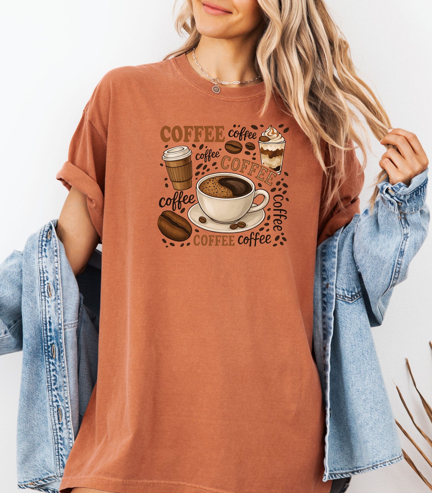Yam t-shirt featuring a playful coffee-themed design with multiple illustrated coffee cups, beans, and the word “coffee” repeated in various fonts and styles. Centered around a steaming cup of coffee on a saucer, this fun and cozy graphic is perfect for caffeine lovers who want to show off their coffee obsession in style.