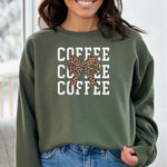 Military Green Gildan sweatshirt featuring a bold white triple “COFFEE” text stacked vertically, accented with a stylish leopard-print coquette bow at the center. A trendy and playful design that blends coffee love with fashionable flair—perfect for cozy mornings and confident, cute style.