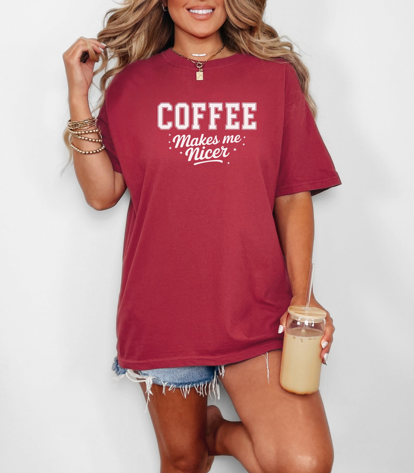 Graphic Chili t-shirt design featuring bold varsity-style white text “COFFEE” with the phrase “makes me nicer” in a playful script underneath, surrounded by small stars. A fun and relatable design perfect for coffee lovers who know their mood improves with caffeine—ideal for casual wear with a humorous twist.