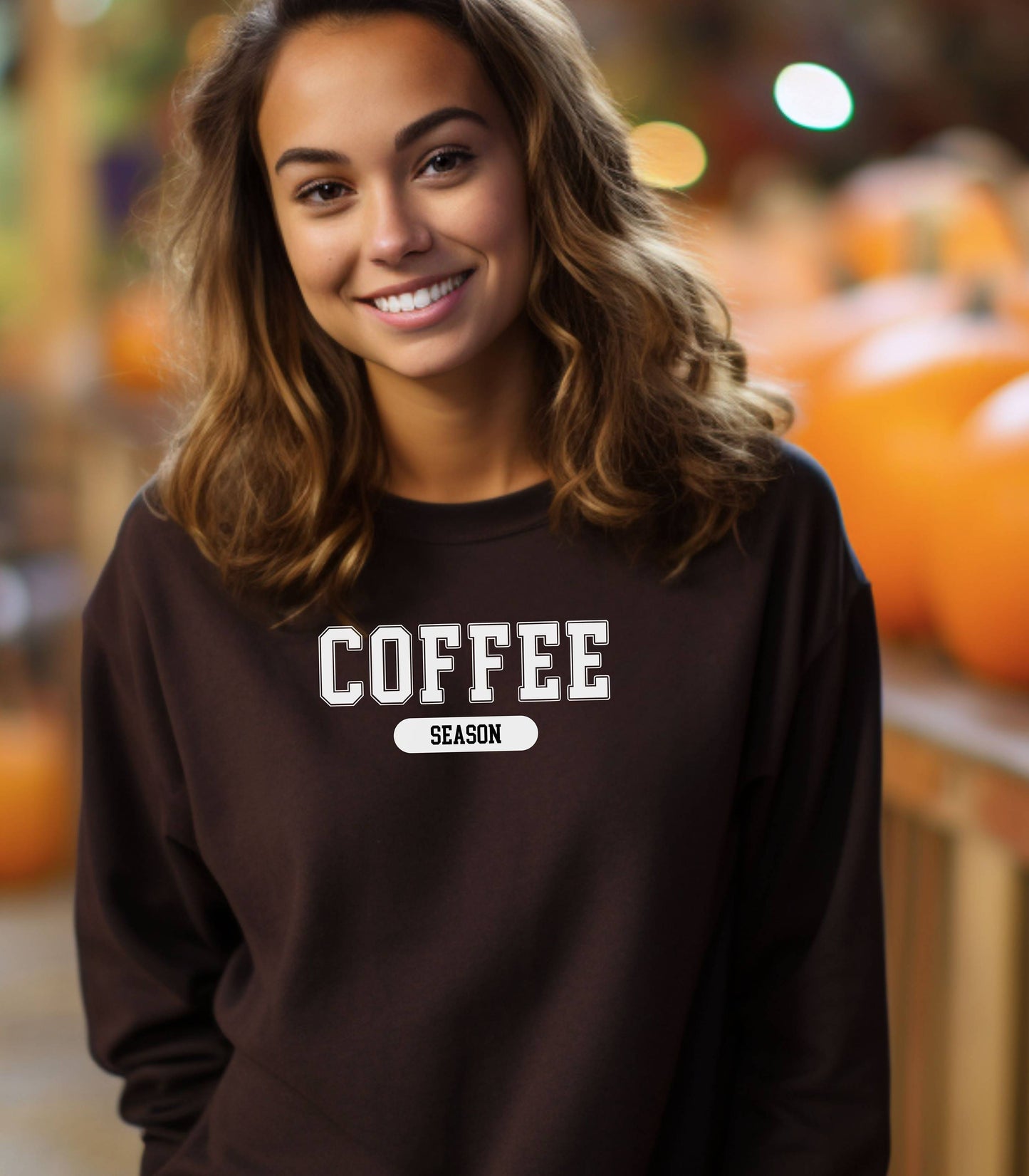 Dark Chocolate sweatshirt featuring a bold “COFFEE” design in varsity-style white lettering with the word “SEASON” underneath in a rounded black label. A cozy and stylish look perfect for coffee lovers embracing their favorite time of year—whether it’s fall, winter, or every season.