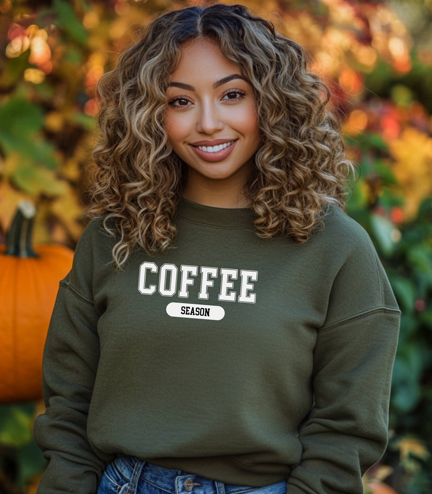 Military Green sweatshirt featuring a bold “COFFEE” design in varsity-style white lettering with the word “SEASON” underneath in a rounded black label. A cozy and stylish look perfect for coffee lovers embracing their favorite time of year—whether it’s fall, winter, or every season.
