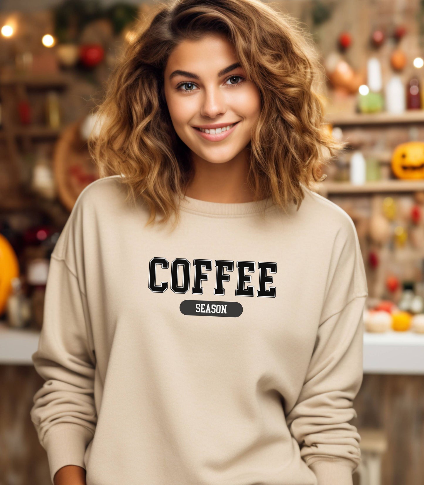 Sand sweatshirt featuring a bold “COFFEE” design in varsity-style black lettering with the word “SEASON” underneath in a rounded black label. A cozy and stylish look perfect for coffee lovers embracing their favorite time of year—whether it’s fall, winter, or every season.
