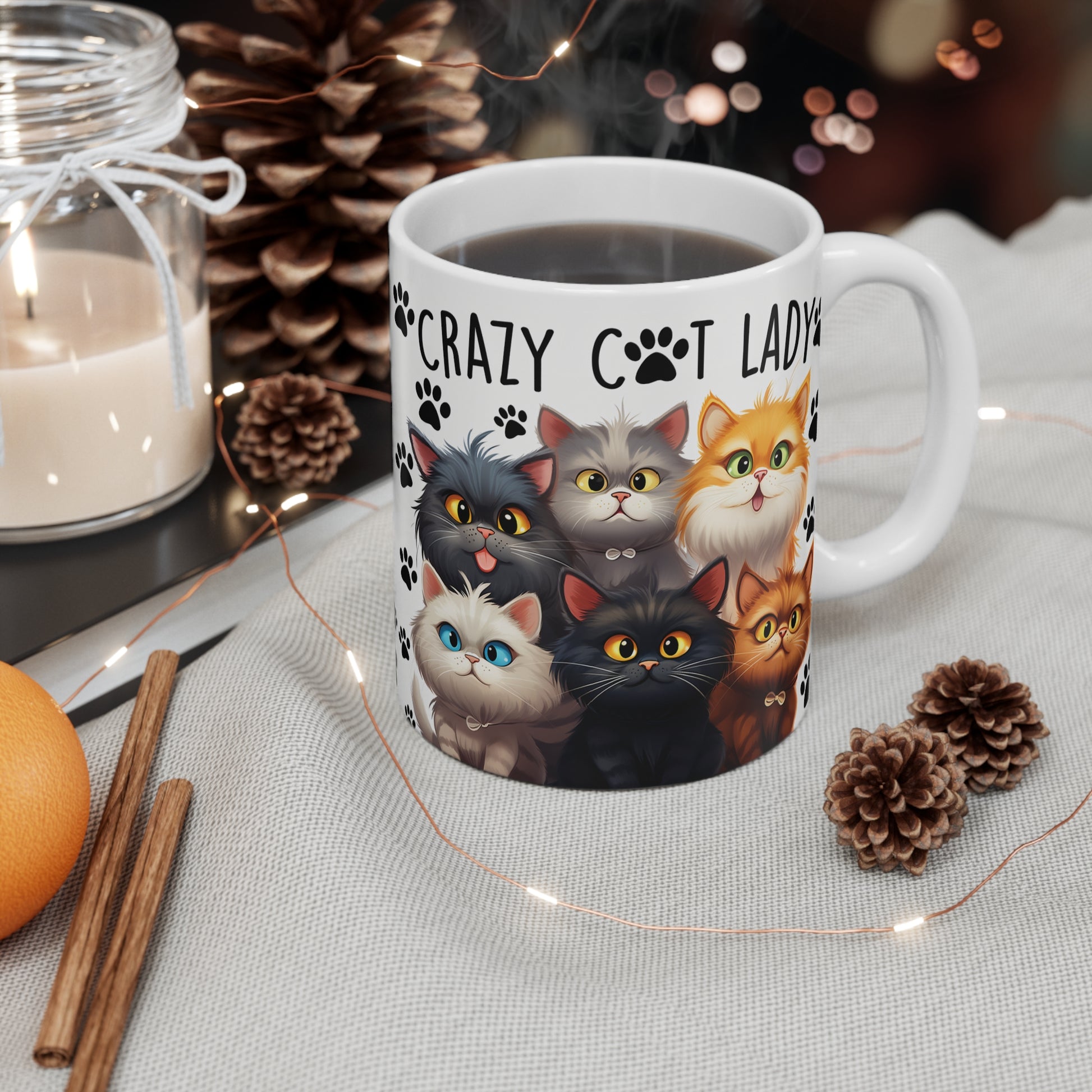 Ceramic Mug with cat design and 'Crazy Cat Lady' text, surrounded by decorative items on a table.
