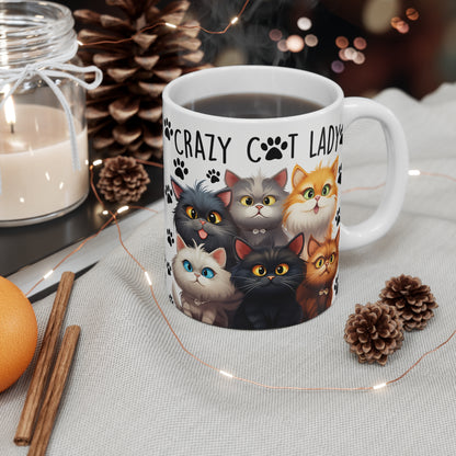 Ceramic Mug with cat design and 'Crazy Cat Lady' text, surrounded by decorative items on a table.