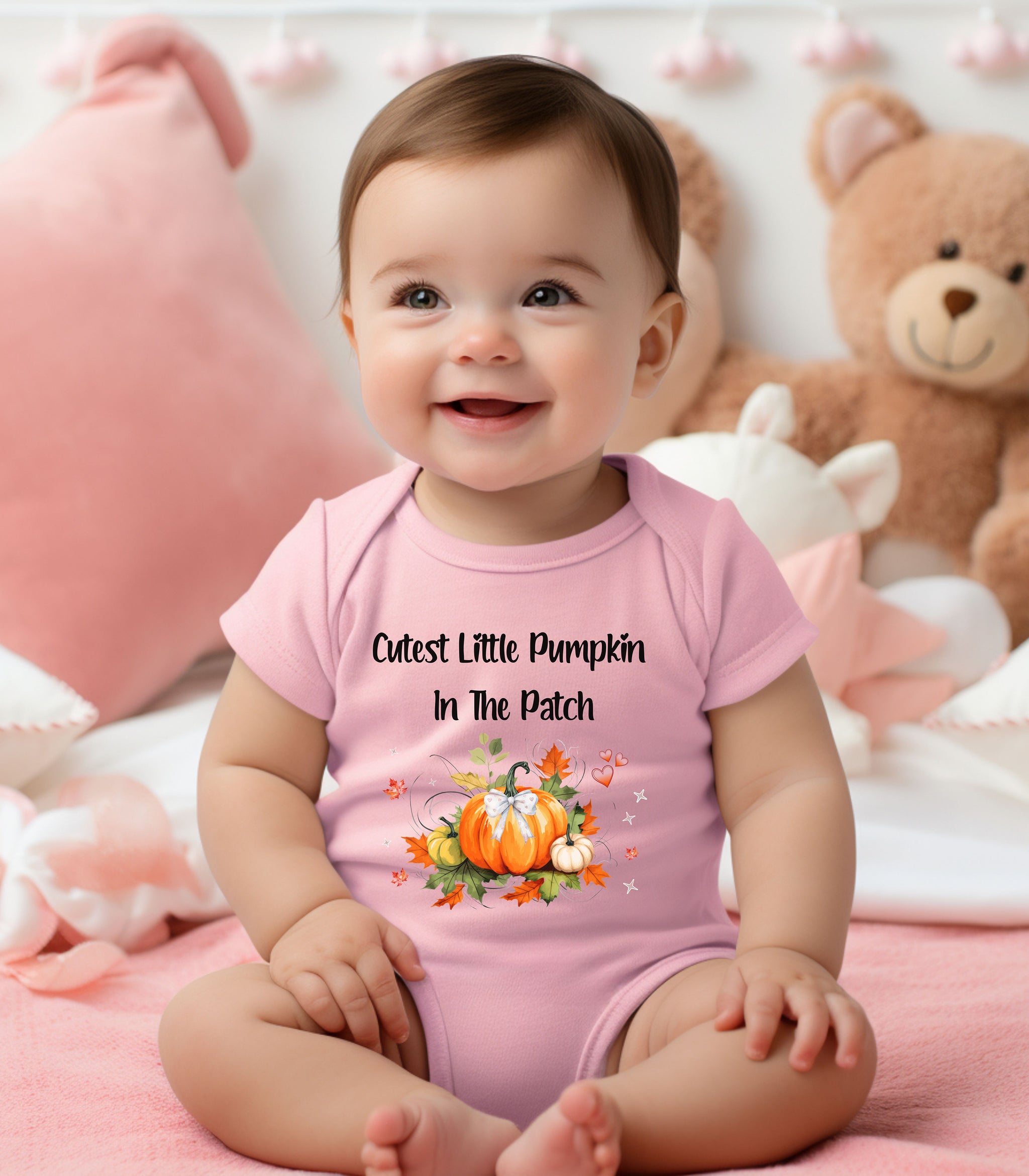 Infant wearing a pink infant bodysuit featuring the phrase "Cutest Little Pumpkin In The Patch" with an adorable fall-themed design of orange and white pumpkins, autumn leaves, hearts, and a sweet bow. Perfect for baby's first fall or pumpkin patch visit.