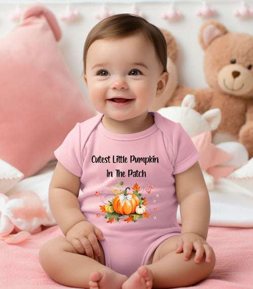 Infant wearing a pink infant bodysuit featuring the phrase "Cutest Little Pumpkin In The Patch" with an adorable fall-themed design of orange and white pumpkins, autumn leaves, hearts, and a sweet bow. Perfect for baby's first fall or pumpkin patch visit.
