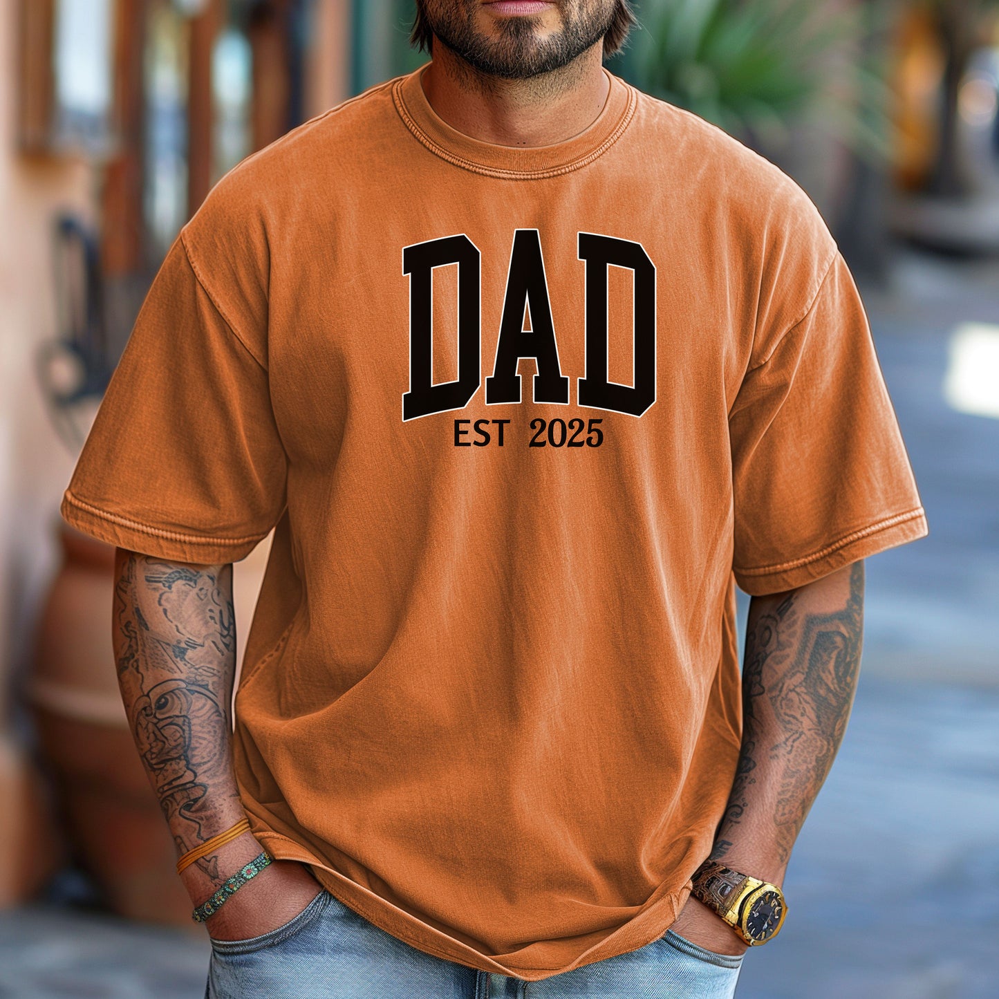 Personalized DAD Est [Year] T-shirt featuring bold varsity-style block lettering with a customizable establishment year. Printed on a soft, relaxed-fit unisex tee in yam, this design is perfect for celebrating new or seasoned fathers. Ideal for Father’s Day, birthdays, or family milestones, offering both comfort and a proud personal touch.