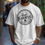Dad’s Barbeque T-shirt featuring a circular badge-style design with the phrases 'The Man. The Myth. The Legend.' and 'Chilling & Grilling.' The center showcases 'Dad’s Barbeque' in bold lettering with a small grill, fork, and spatula icons. Printed on a classic white unisex tee, this shirt is perfect for BBQ-loving dads and makes a fun Father’s Day or birthday gift.