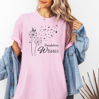 Whimsical dandelions with flying seeds, butterflies, and dragonflies pop in black and white ink against a soft blossom pink Comfort Colors tee. Elegant nature motif with clean text that says "Dandelion Wishes".