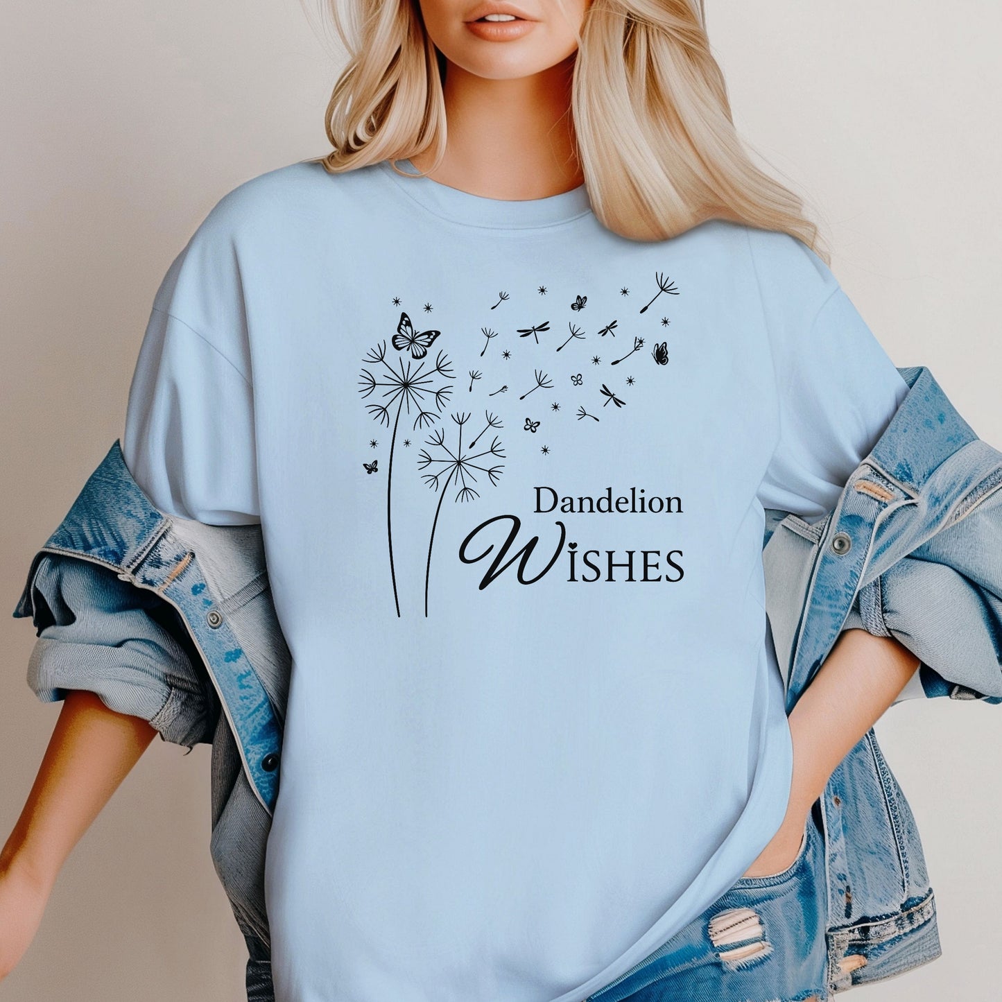 Whimsical dandelions with flying seeds, butterflies, and dragonflies pop in black and white ink against a soft chambray (light blue) color Comfort Colors tee. Elegant nature motif with clean text that says "Dandelion Wishes".